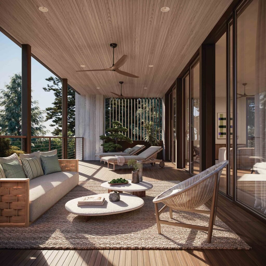 Covered outdoor terrace with lounge seating and ceiling fans overlooking lush greenery at a Kiawah Island luxury rental.